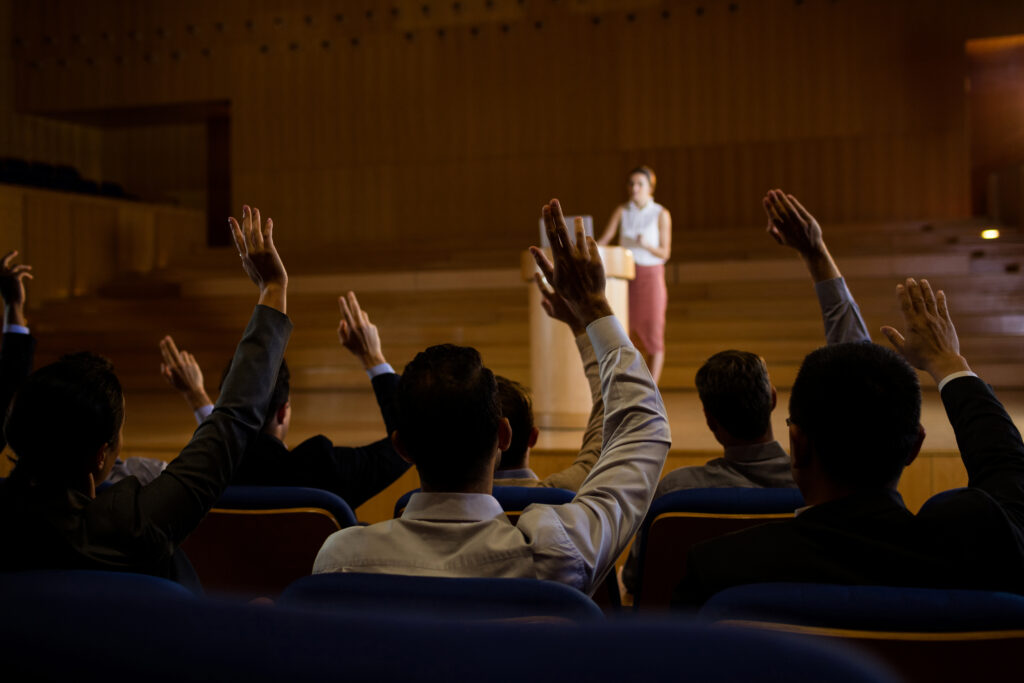 female business executive giving a speech at conference center